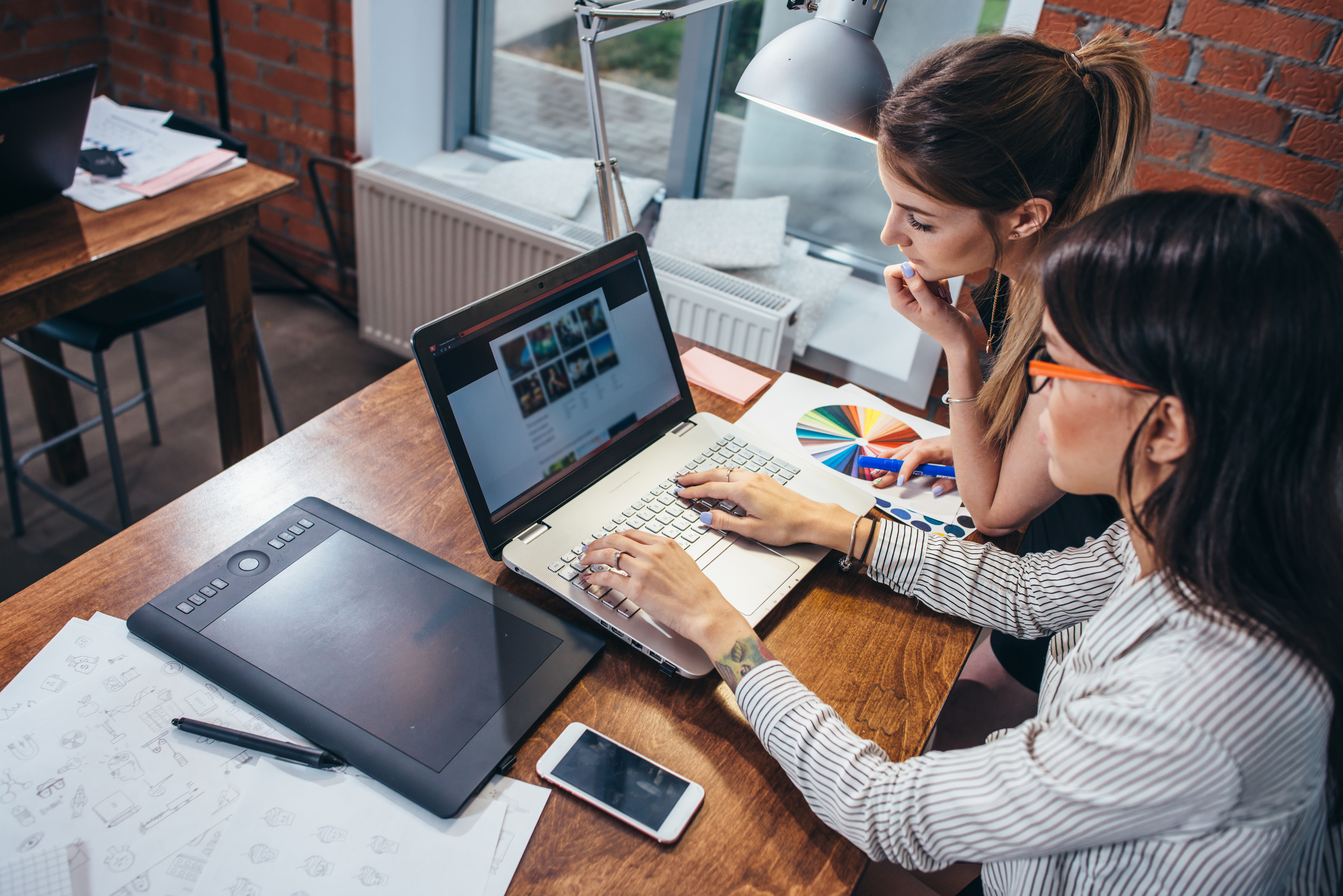 Two designers collaborating on a website